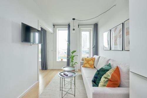 a living room with a couch and a table at Elegant Cozy Modern Free Parking in Copenhagen