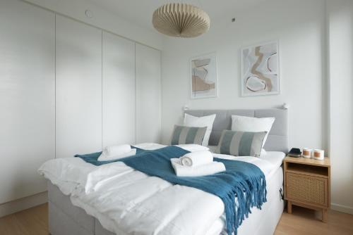 a bedroom with a large bed with a blue blanket at Elegant Cozy Modern Free Parking in Copenhagen