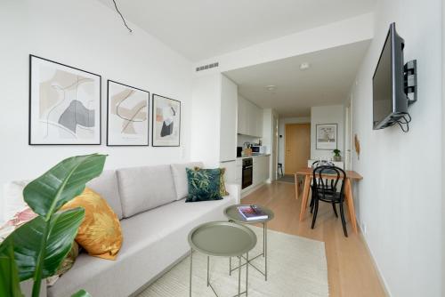 a living room with a couch and a table at Elegant Cozy Modern Free Parking in Copenhagen