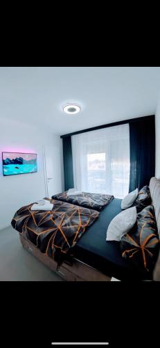 a large bed in a room with a window at Bella Vista Sunset penthouse with private jacuzzi in Novalja