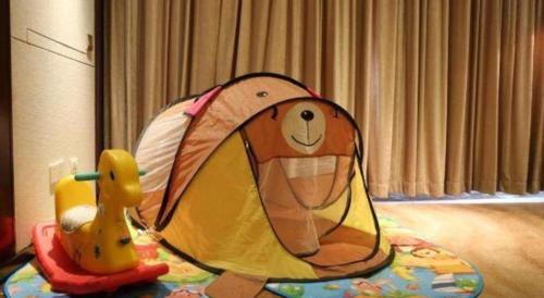 a toy dog in a tent on a table at Weida Hotel Jinhua in Jinhua