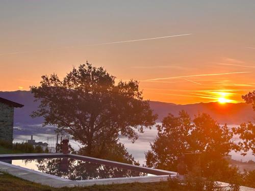 a sunset view from the roof of a house at Poggelleri la cartolina su Poppi e le colline toscane in Poppi