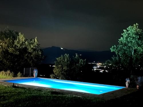 a swimming pool lit up at night at Poggelleri la cartolina su Poppi e le colline toscane in Poppi