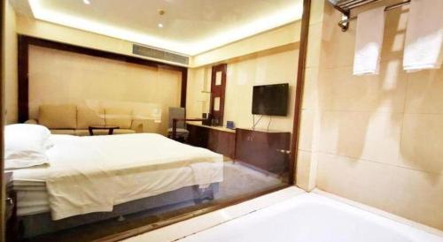 a hotel room with a bed and a television at Starmoon Hotel in Beijing