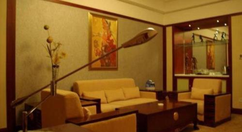 a living room with a couch and a table at Dunhuang Grand Soluxe Hotel in Dunhuang