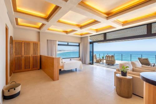a living room with a view of the ocean at Cabo Break Hotel in San José del Cabo