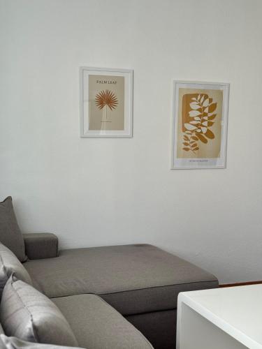 a living room with a couch and two pictures on the wall at Lena in Jajce