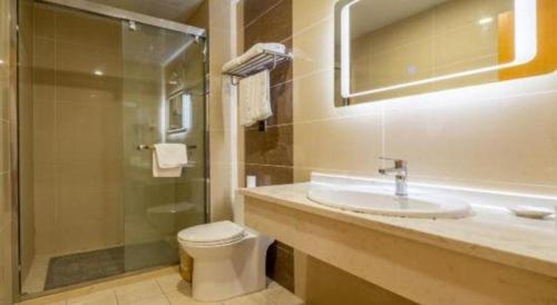 a bathroom with a toilet and a sink and a shower at GreenTree Inn Shanghai Railway Station Macao Road in Shanghai