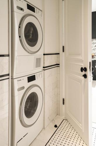 a laundry room with two washer and dryer at Opartment - People's Square 远东饭店 - 人民广场 in Shanghai