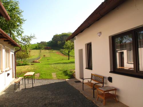 a patio with benches and a view of a yard at Chalupa U Vinaře in Radějov