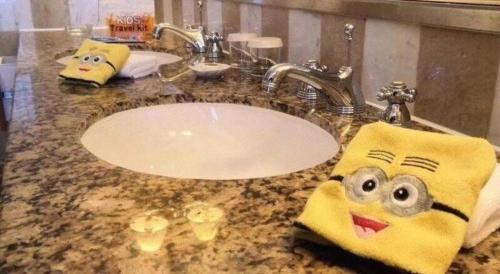 a bathroom sink with two towels with faces on it at Kai Wah Plaza International Hotel in Kunming