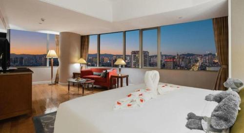 a bedroom with two teddy bears sitting on a bed at Kai Wah Plaza International Hotel in Kunming