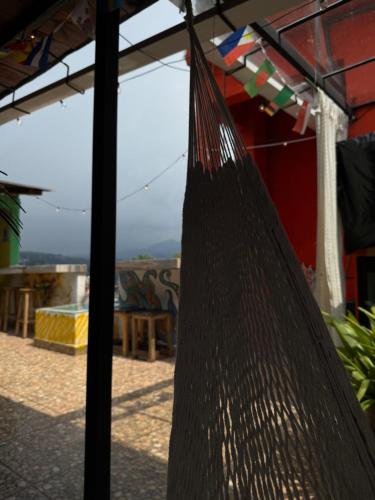 a hammock hanging from a pole in a patio at Hostal el Alebrije in Valle de Bravo