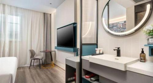 a bathroom with a sink and a mirror at ibis Dongguan Dongcheng in Dongguan