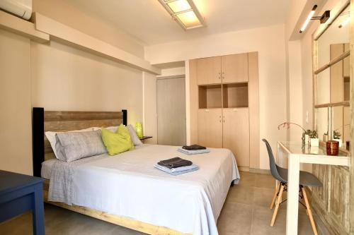 a bedroom with a bed and a table and a chair at FantaSea Apartment in Vlikhón
