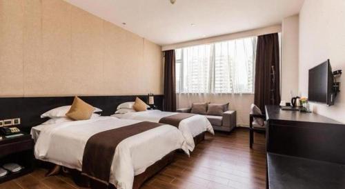 a hotel room with two beds and a couch at H Life Hotel Nanshan Branch in Shenzhen