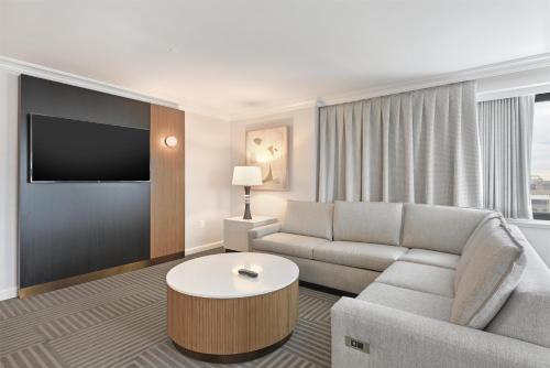 a living room with a couch and a tv at Capital Hilton in Washington