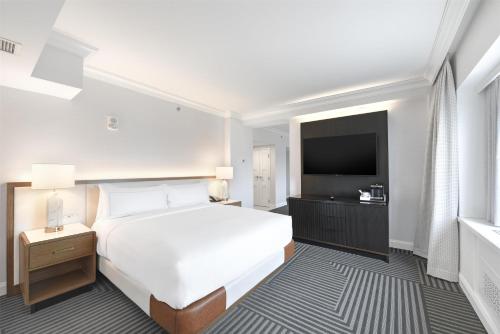 a hotel room with a bed and a television at Capital Hilton in Washington