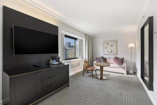 a living room with a large flat screen tv at Capital Hilton in Washington
