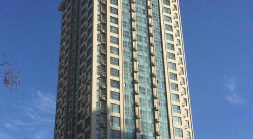 a tall white building with many windows on it at GreenTree Inn Weihai Liugongdao Wharf Qingdao North Road Express Hotel in Weihai