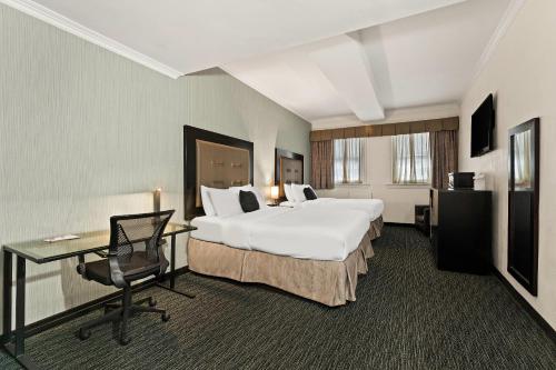 a hotel room with a large bed and a desk at Quality Inn Philadelphia Center City in Philadelphia