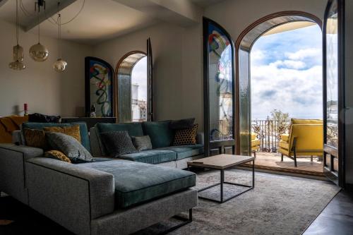 a living room with a couch and a table at Casa Amici - Luxe in Cadaqués in Cadaqués