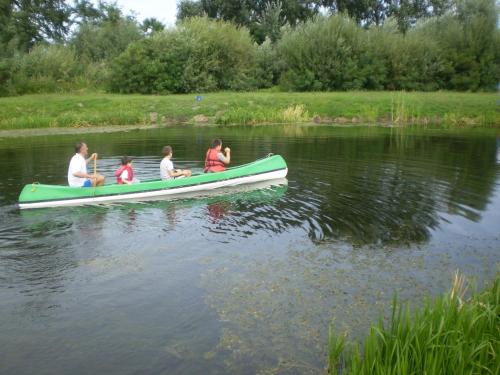 a group of people in a canoe on the water at Katarina Birtok in Nemesnádudvar