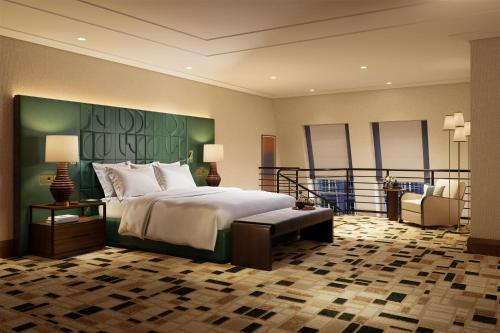 a hotel room with a bed and a balcony at Conrad Hamburg in Hamburg