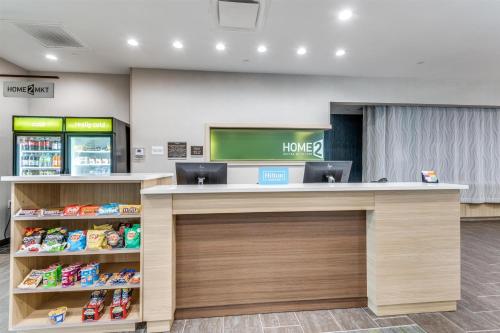 an office with a counter with a home sign on the wall at Home2 Suites By Hilton Dallas Medical District Lovefield, Tx in Dallas