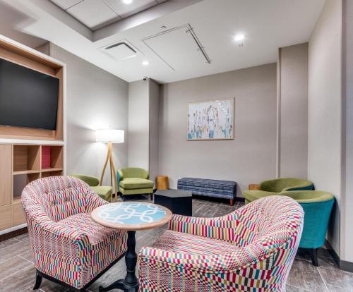 a waiting room with two chairs and a table at Home2 Suites By Hilton Dallas Medical District Lovefield, Tx in Dallas