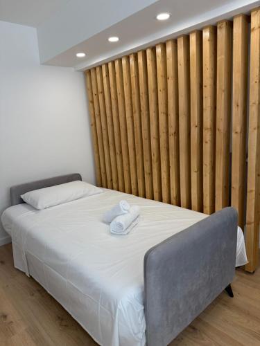 a bedroom with a bed with two towels on it at La Perla Apartment in Taranto