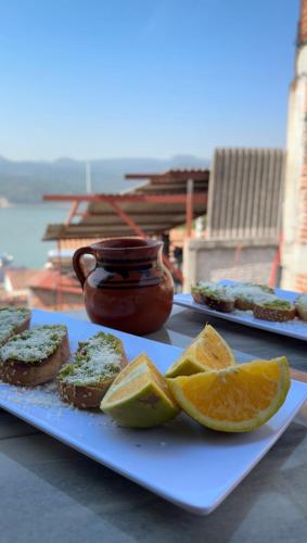 a plate of food with orange slices on a table at Hostal el Alebrije in Valle de Bravo