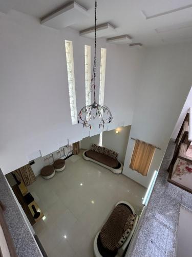 an overhead view of a living room with a chandelier at Manjul Bungalow in Nashik