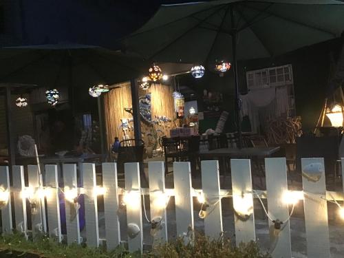 a white picket fence with lights on it at night at B&G Crafs Art House in Chenggong