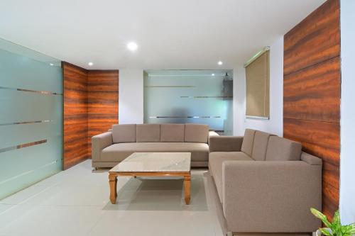 a living room with two couches and a coffee table at My hotel Sector 23 Near Yashobhoomi Dwarka in New Delhi