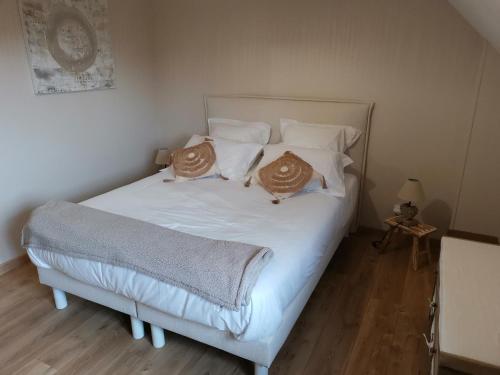 a bedroom with a bed with two pillows on it at Gite Etretat in Sainte-Marie-au-Bosc