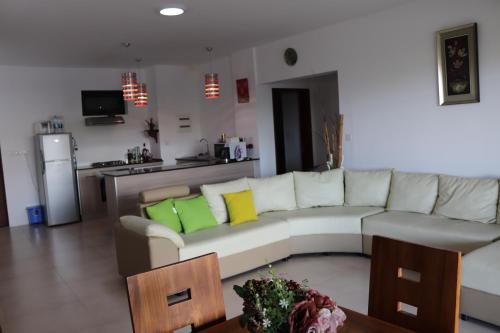 a living room with a couch and a table at Mahina Luxury 2 Bedroom Apartment with Pool in Flic-en-Flac