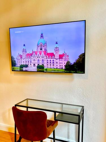 a picture of a large building on a wall at City Comfort Suite Anviolhomes in Hannover