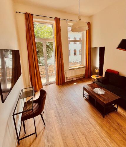 a living room with a couch and a table at City Comfort Suite Anviolhomes in Hannover