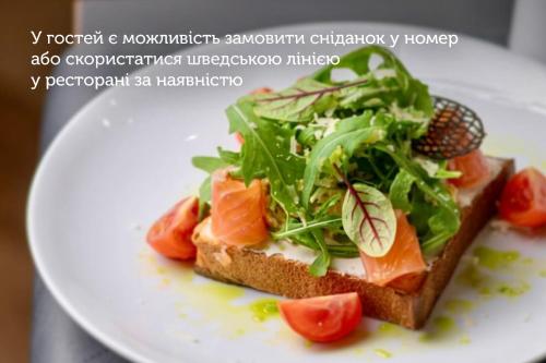 a white plate with a sandwich and salad on it at Black Sea Central in Odesa