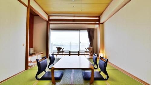 a dining room with a table and chairs at Hotel Harvest Nankitanabe in Tanabe
