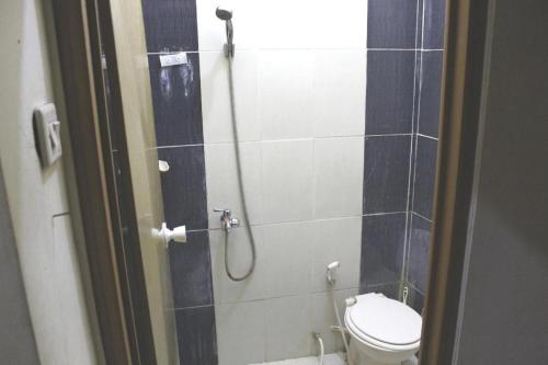 a bathroom with a shower with a toilet in it at OYO Life 2982 Griya Aisyah Residence 2 in Kedurus