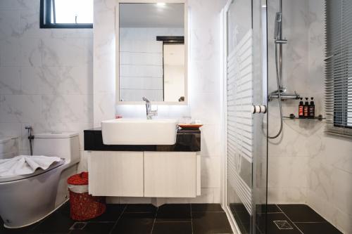 a bathroom with a sink and a toilet at Cmor by Recall Hotels SHA Extra Plus in Chiang Mai