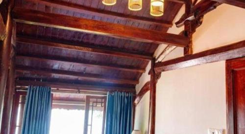 a wooden ceiling in a room with a window at Jun's Home in Buon Ma Thuot
