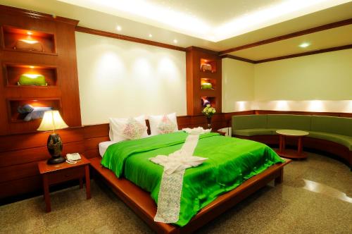 a room with a bed with a cross on it at Busyarin Hotel in Nong Khai