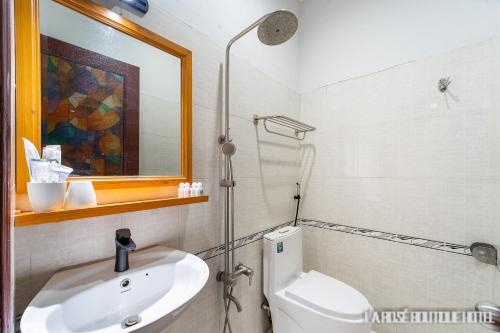 a bathroom with a toilet and a sink and a mirror at La Rose Sai Gon Hotel in Ho Chi Minh City