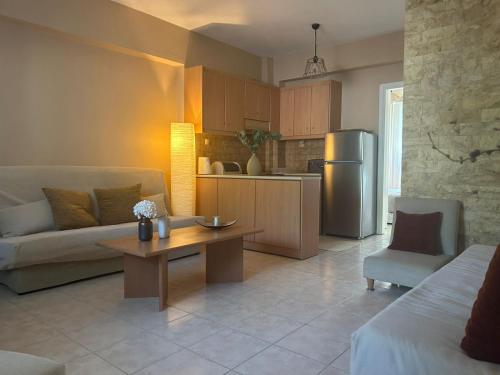 a kitchen and living room with a couch and a table at Mola Breeze in Mola Kalyva