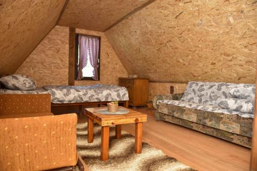 a living room with two couches and a table at Vikendica Boske in Lazići
