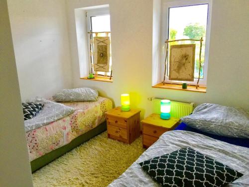 a bedroom with two beds and two candles on tables at Pension Horn in Schkopau