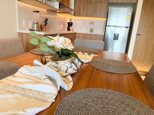 a dining room table with chairs and a kitchen at Luxury Oceanview 2BR La Cruz de Huanacaxtle in Cruz de Huanacaxtle